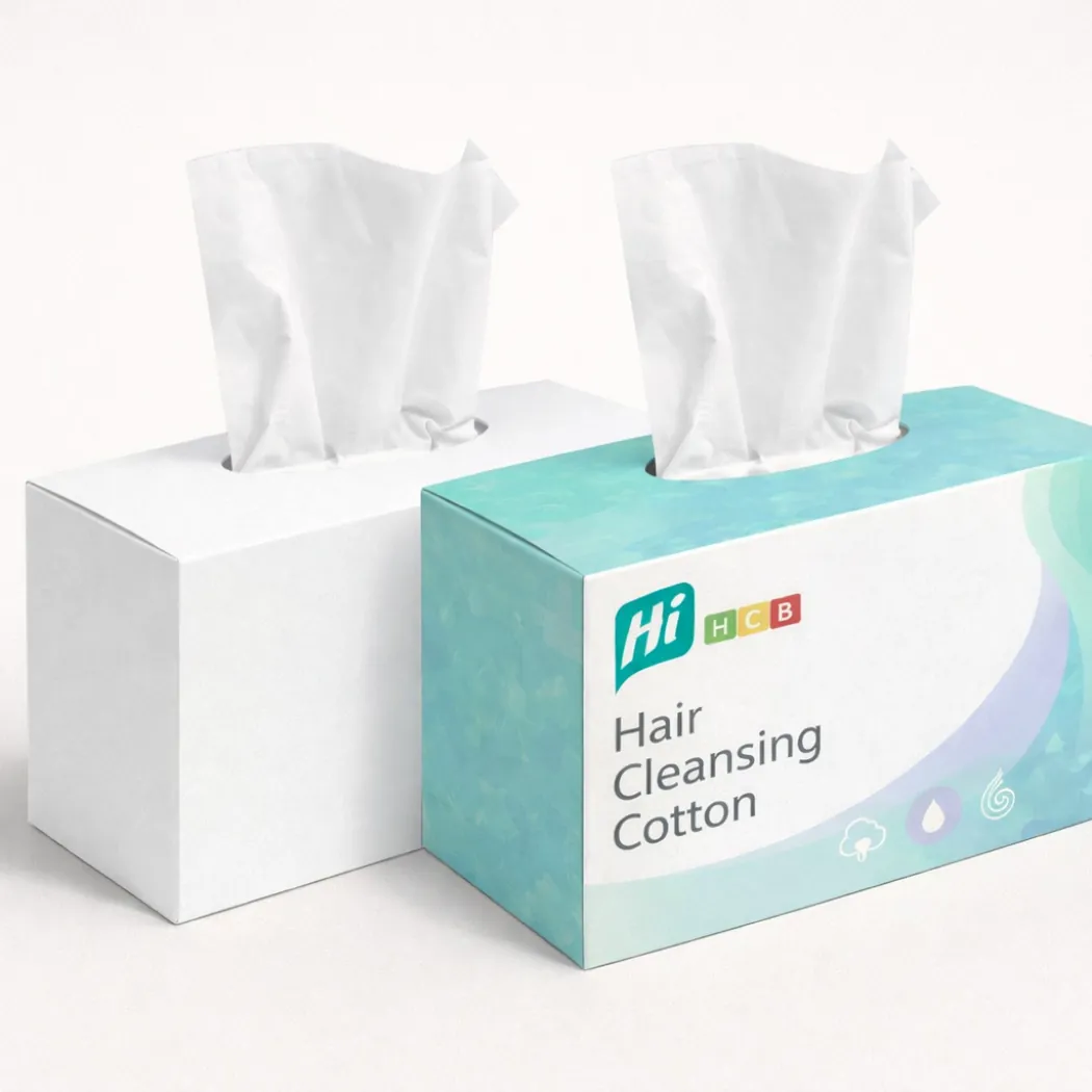 Two horizontal dispenser boxes for hair cleansing cotton- showing tissues being pulled from the top- class=